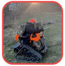 Woman shoots a crossbow from her track chair.